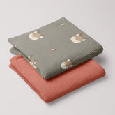 Folded set of Forest Deer muslin swaddle and terra cotta muslin blanket